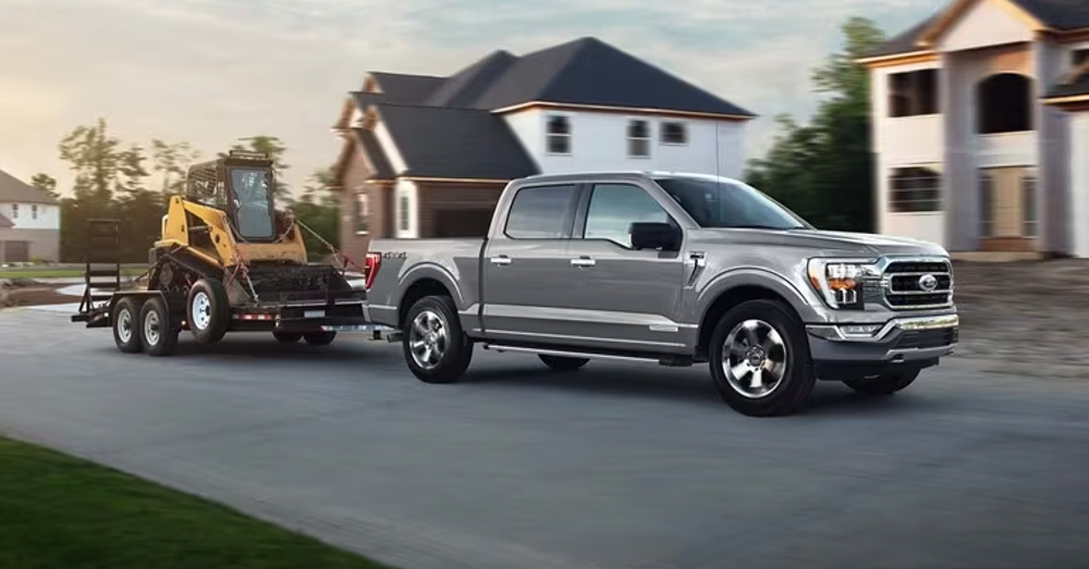 Truck towing Construction Equipment